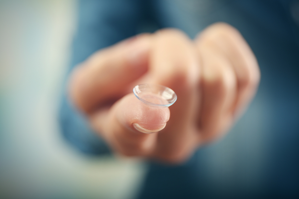 contact lens on person finger